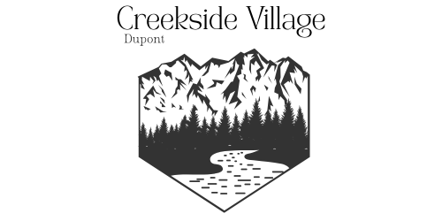 A black and white image of a mountain range with a river running through it and the words "Creekside Village Dupont" above it.
